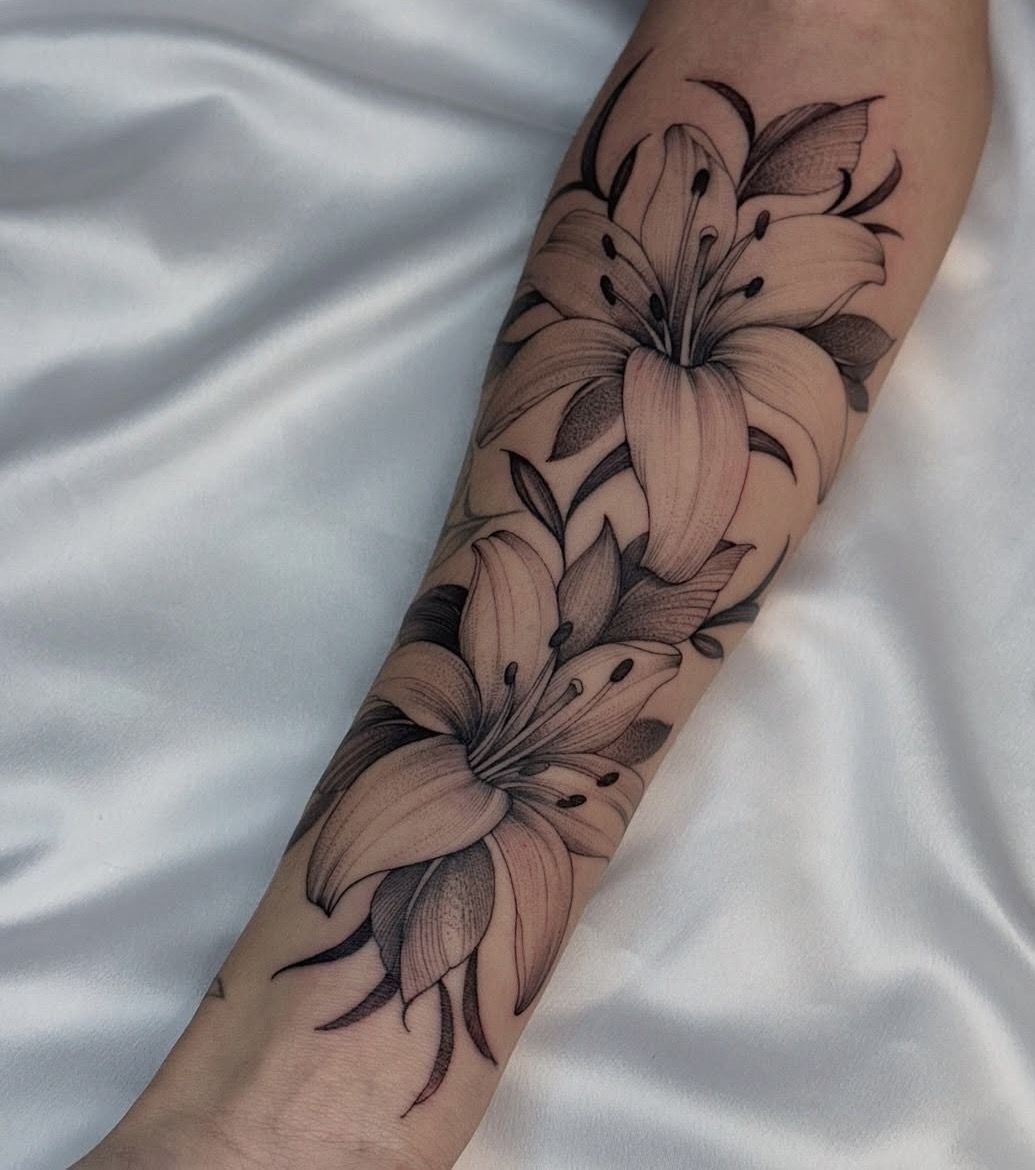 Flowing Botanical Lily Tattoo, a tattoo design rendered in bold.