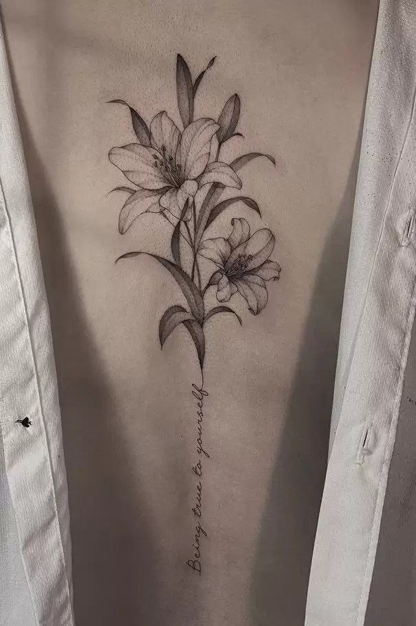 Poetic Stem Lily Tattoo, a tattoo design rendered in delicate fine-line.