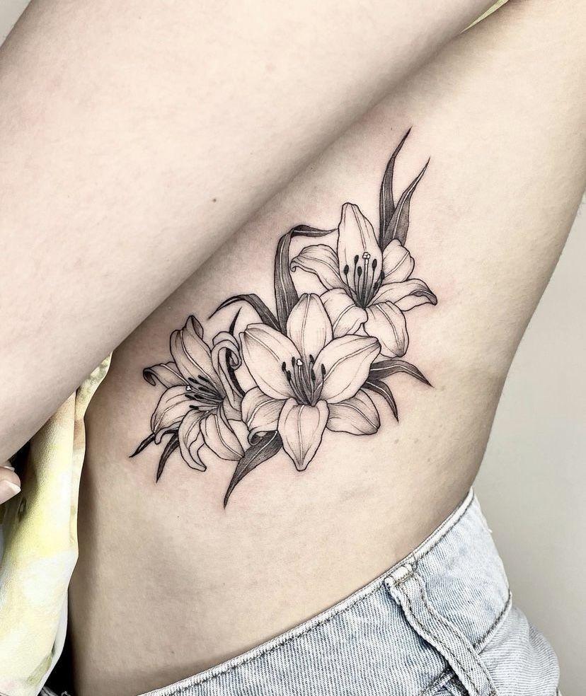 Soft Side Lily Bouquet Tattoo, a tattoo design rendered in clean detailed linework for the leg.
