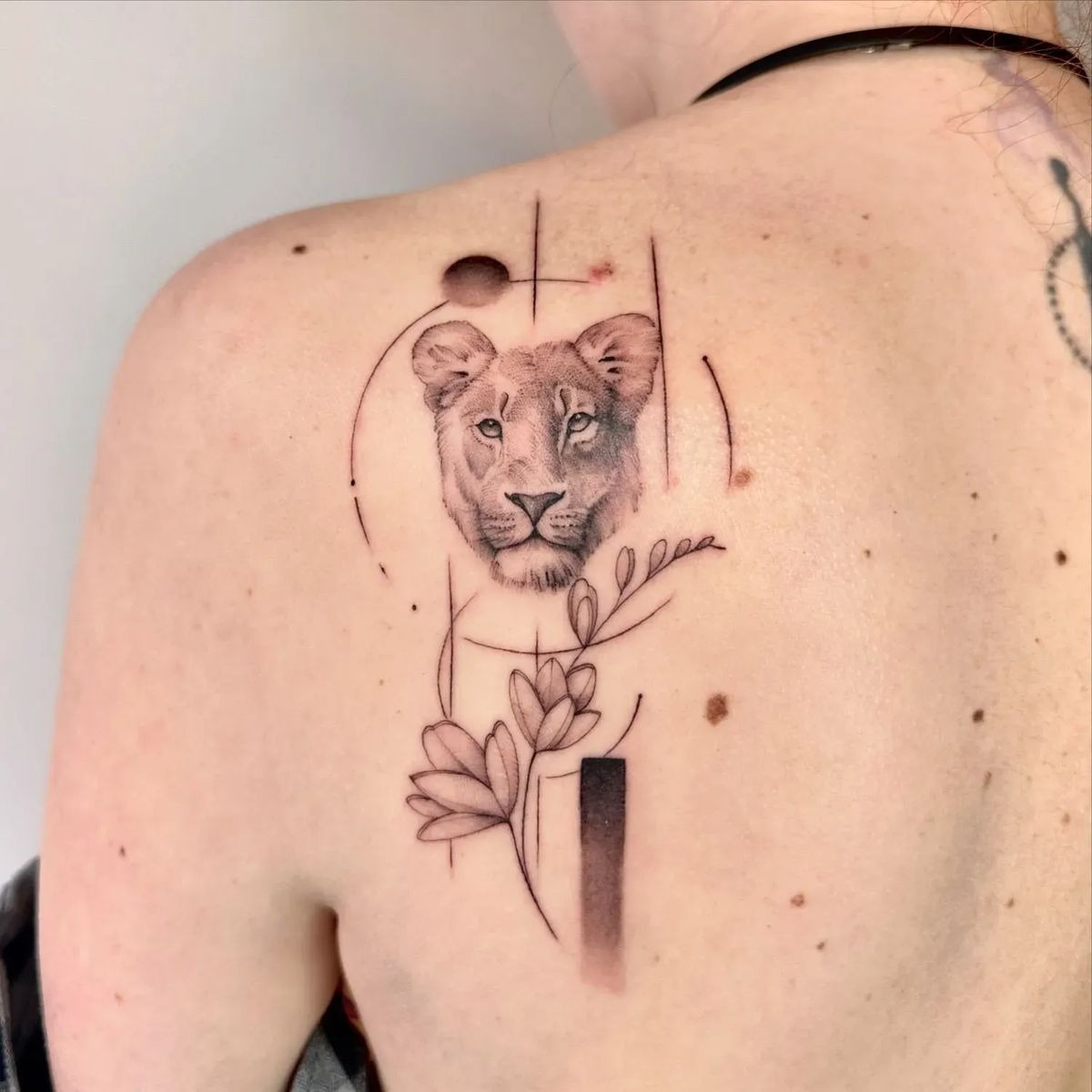 Fine-Line Lioness with Abstract Botanicals (Upper Back) Tattoo Design