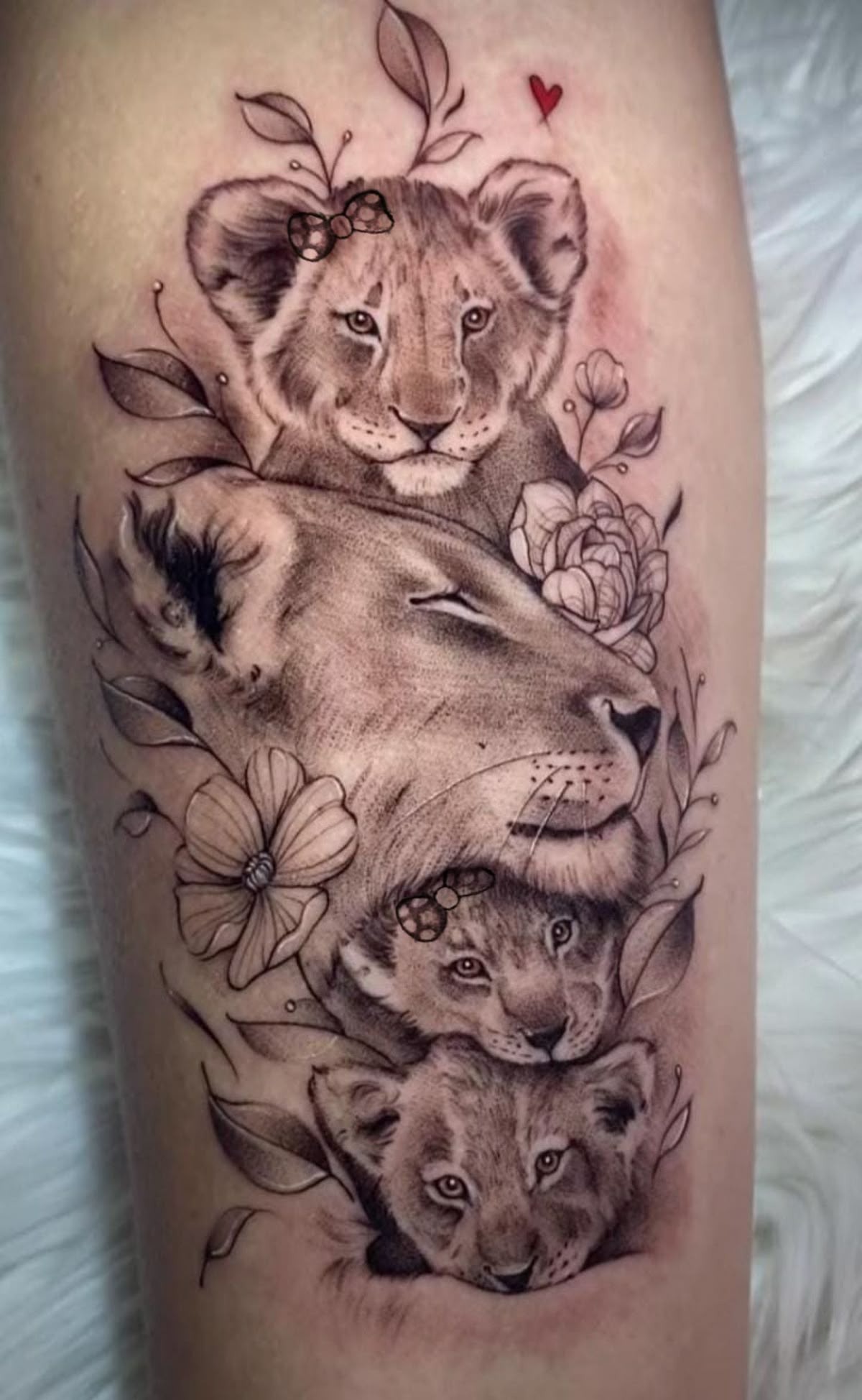 Nestled Pride: Lioness with Three Cubs Tattoo Design