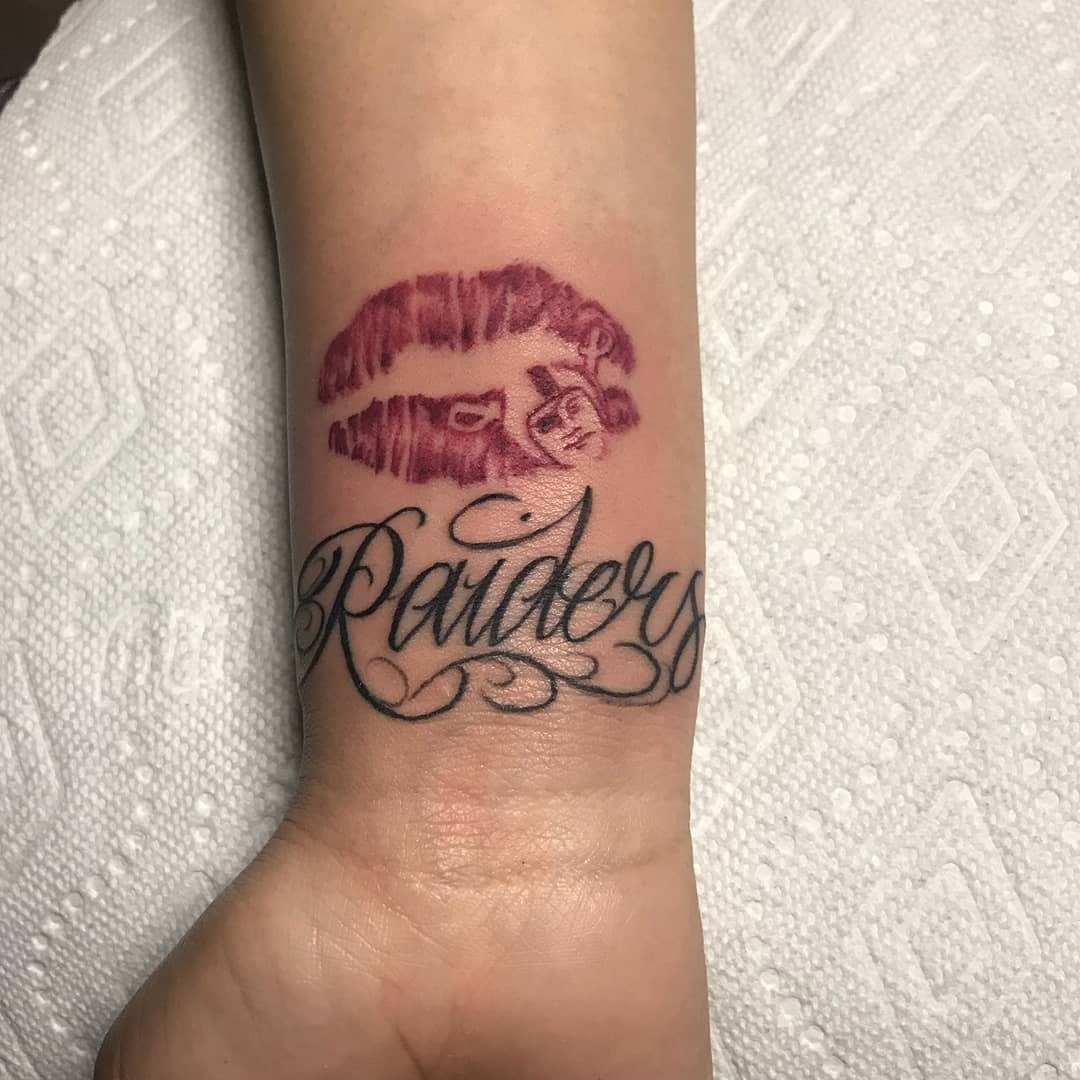 Stylish Lips and Raiders Tattoo Combination Tattoo Design