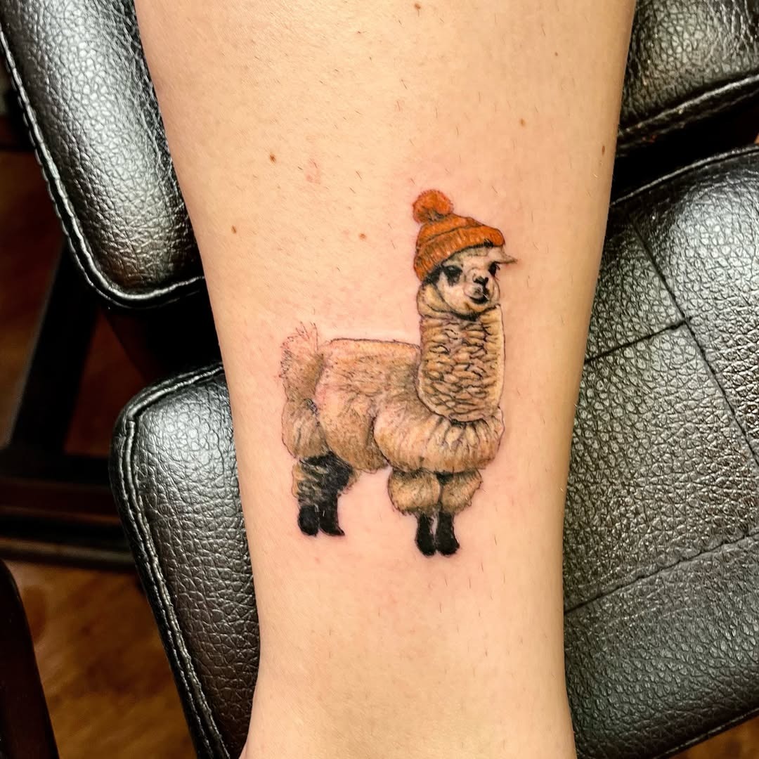 Charming llama tattoo with a winter hat Tattoo Design