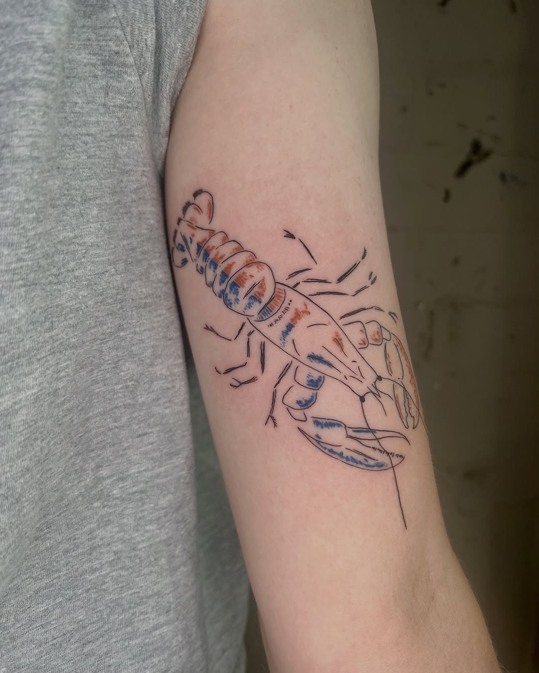 Colorful lobster tattoo on bare arm Tattoo Design