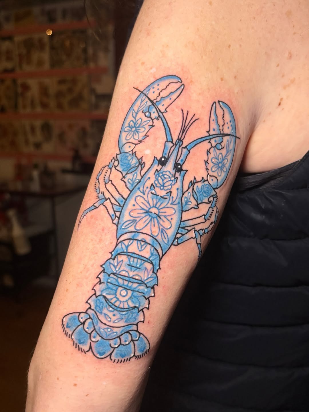 Elegant lobster tattoo with floral accents Tattoo Design