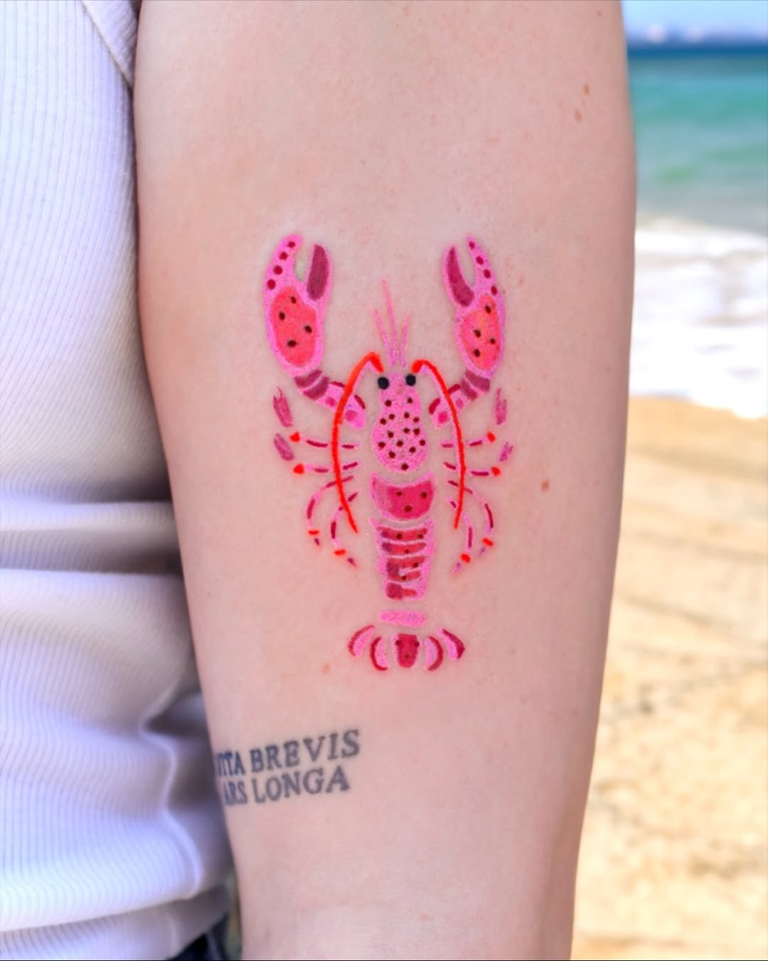 Vibrant lobster tattoo with beach backdrop Tattoo Design