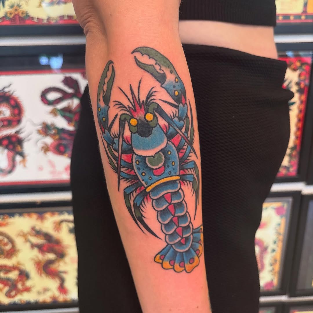 Vivid lobster tattoo on forearm showcasing color Tattoo Design