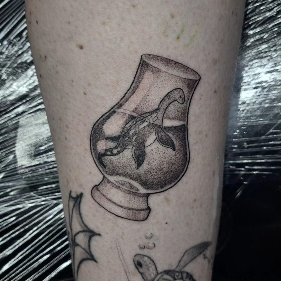 Charming Loch Ness Monster in a Glass Design Tattoo Design
