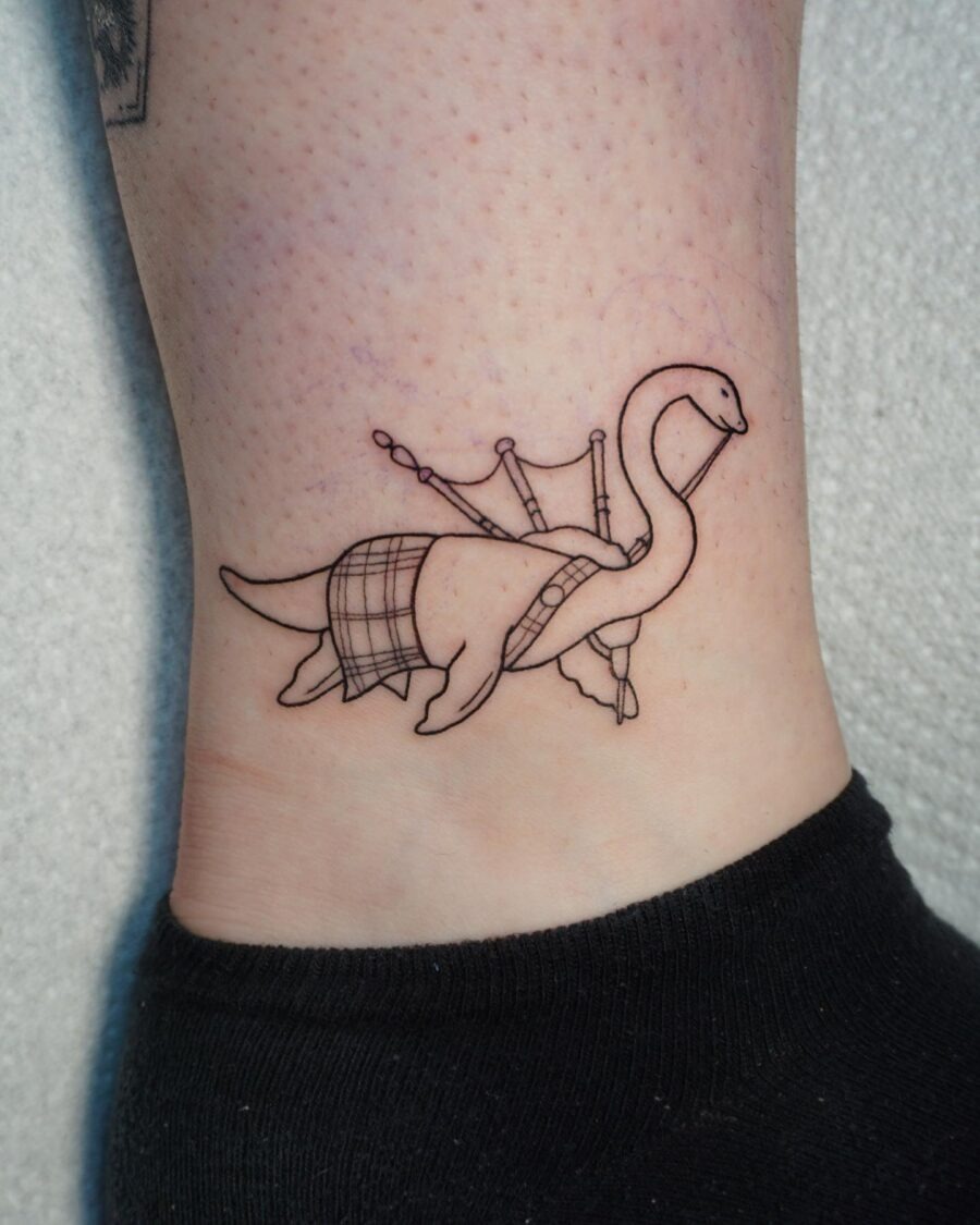 Charming Loch Ness Monster Tattoo with Bagpipes Tattoo Design