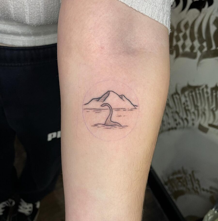 Charming Loch Ness Monster with Scenic Background Tattoo Design