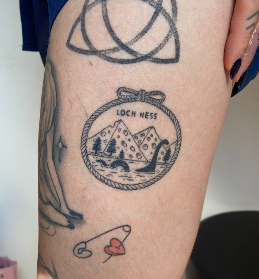 Charming Loch Ness Tattoo with Scenic Elements Tattoo Design
