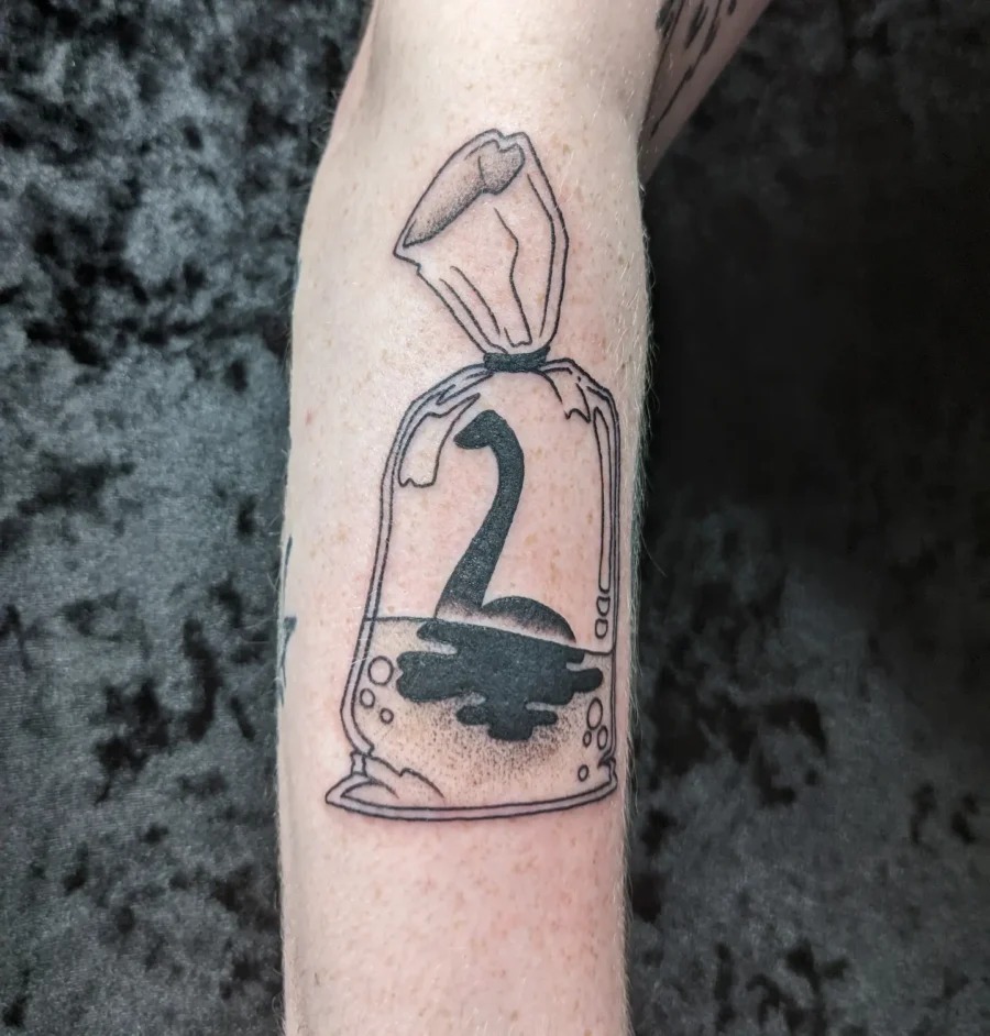 Unique Loch Ness Monster in a Bag Tattoo Tattoo Design