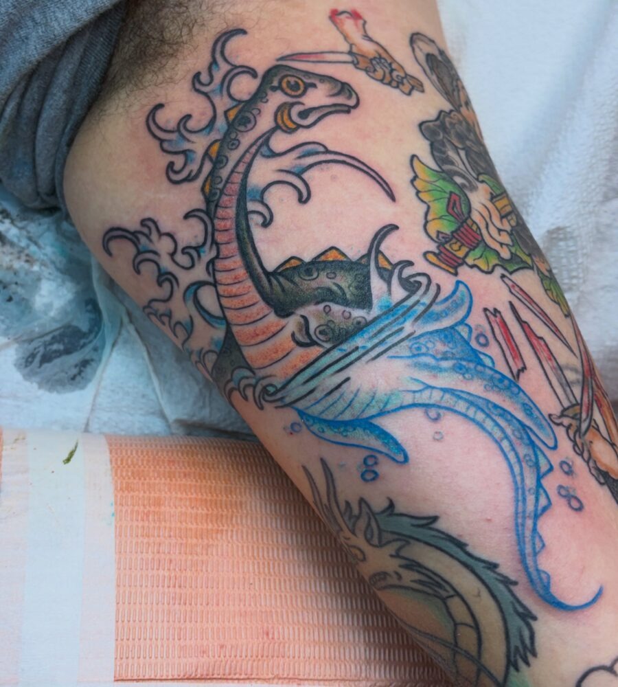 Vibrant Loch Ness Monster Tattoo in Motion Tattoo Design