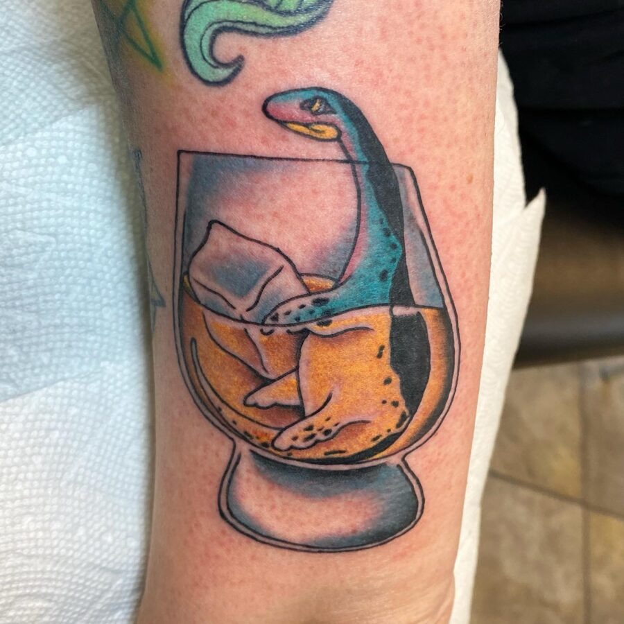 Whimsical Loch Ness Monster Tattoo in Glass Tattoo Design