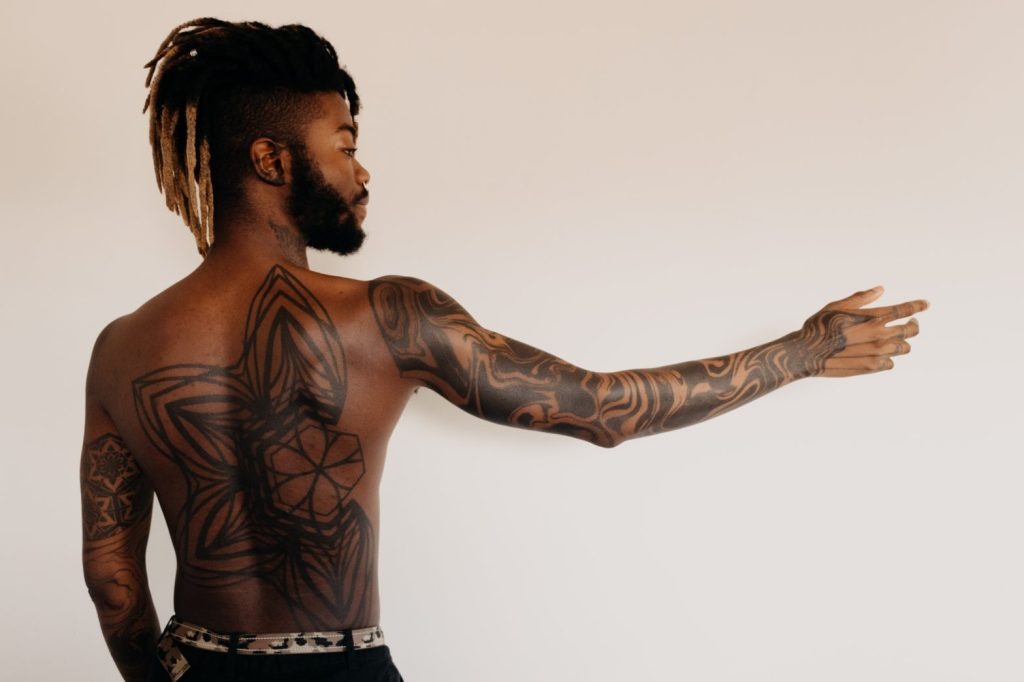 Geometric and Tribal-Inspired Full Back and Sleeve Tattoo Tattoo Design