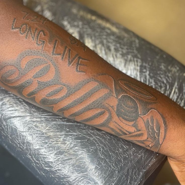 Honoring Rellz with Bold Script Tattoo Design