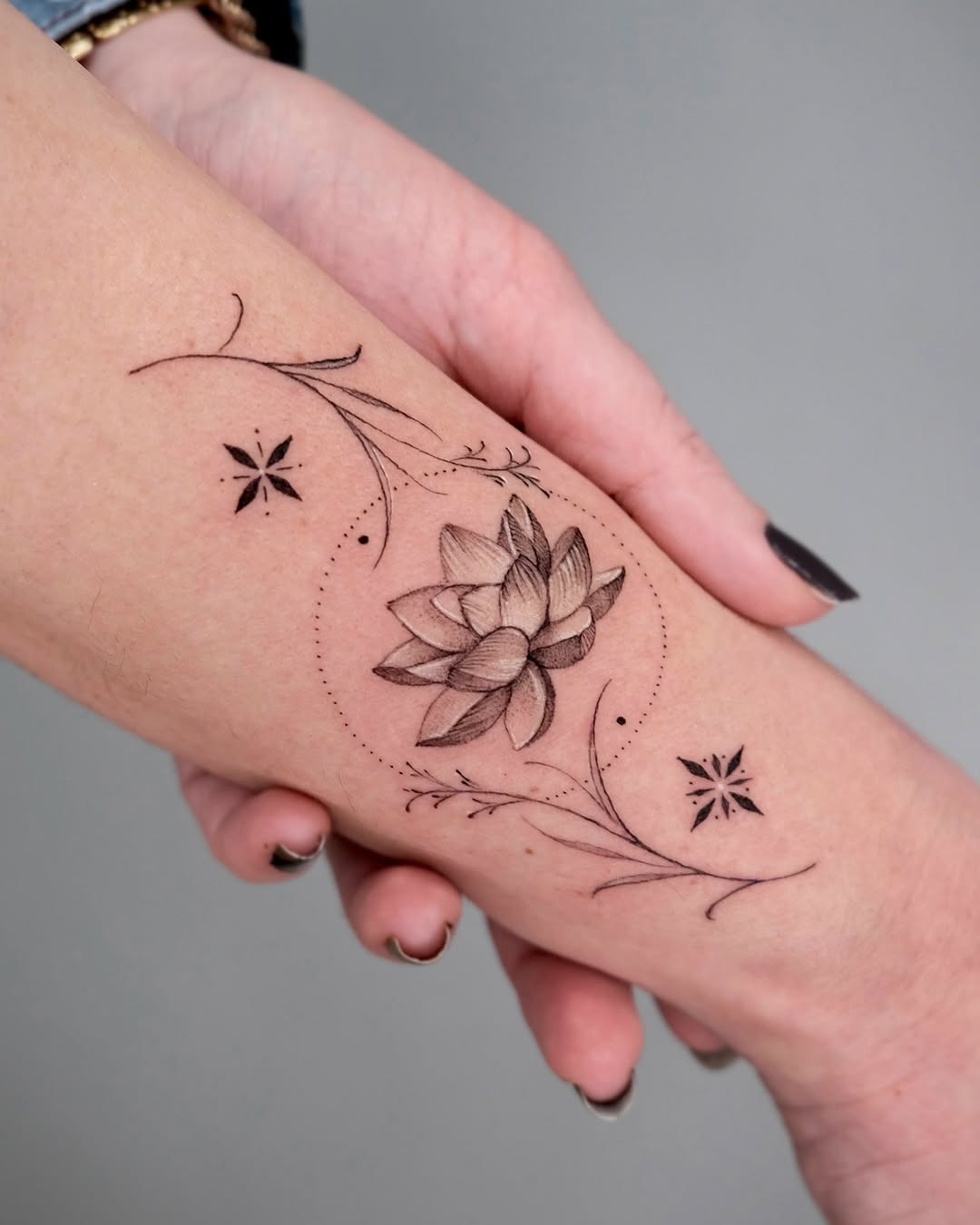 Delicate lotus tattoo with elegant floral accents Tattoo Design