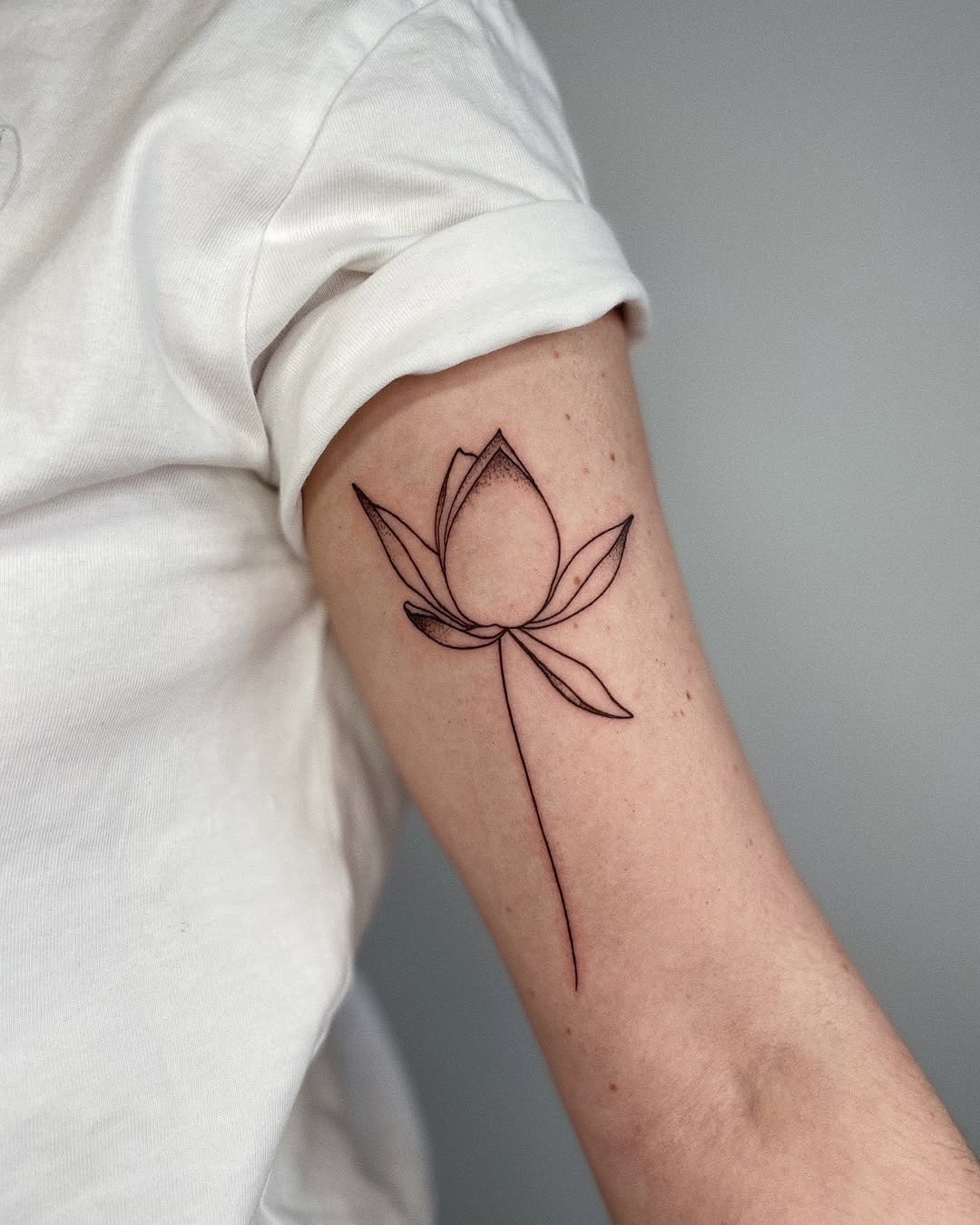 Elegant lotus blooms with meaningful script decoration Tattoo Design