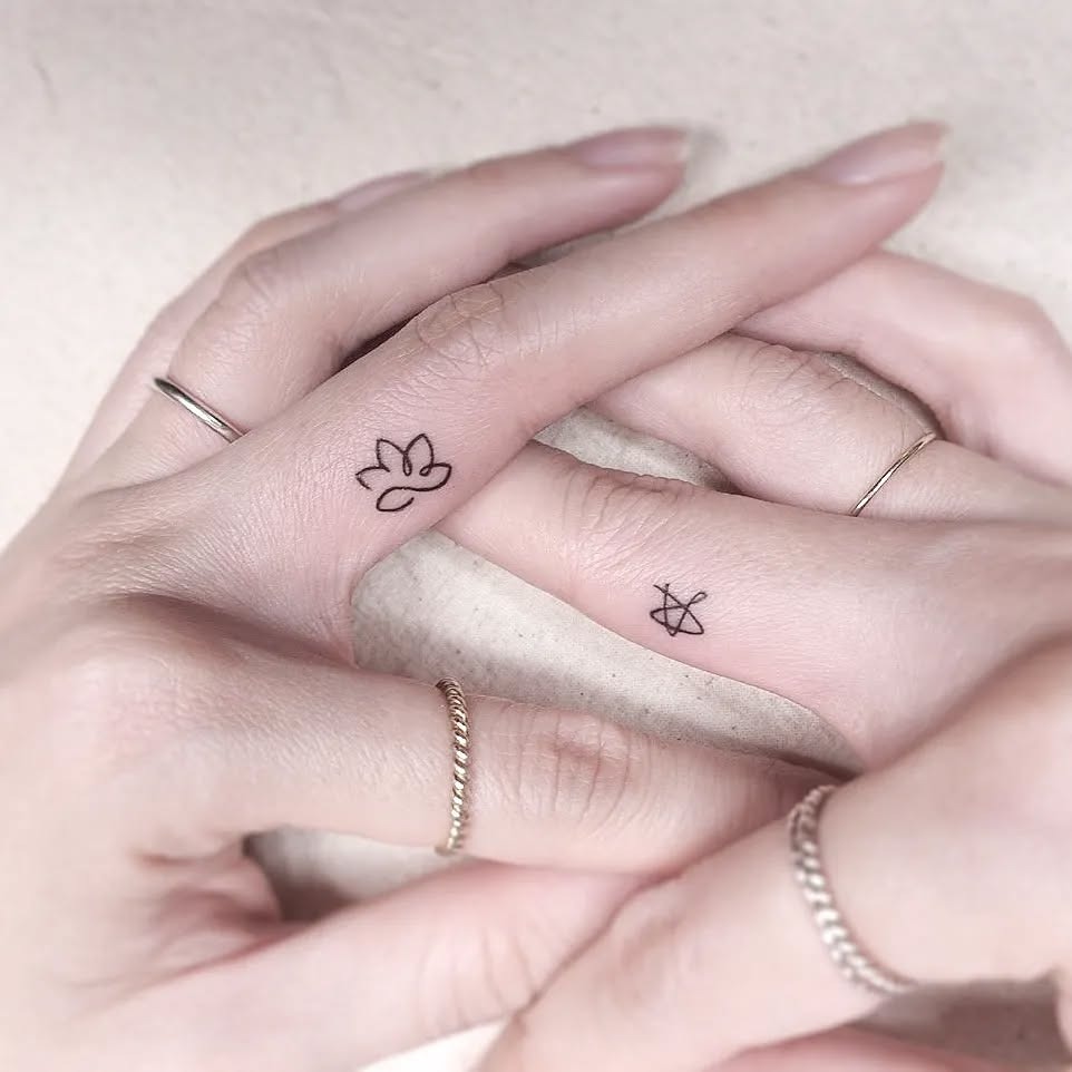 Elegant lotus tattoo on delicate fingers Tattoo Design