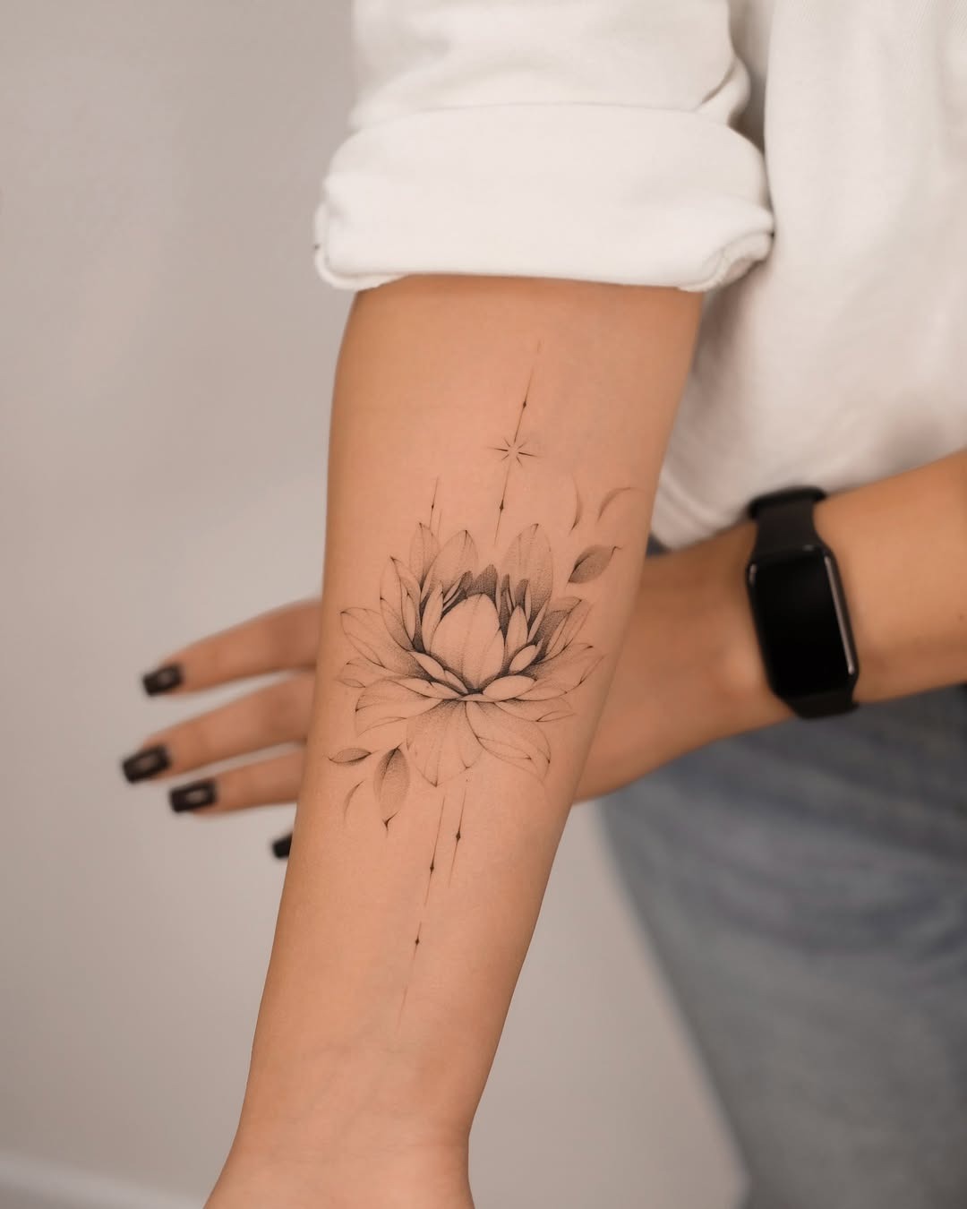 Elegant lotus tattoo with floral accents Tattoo Design