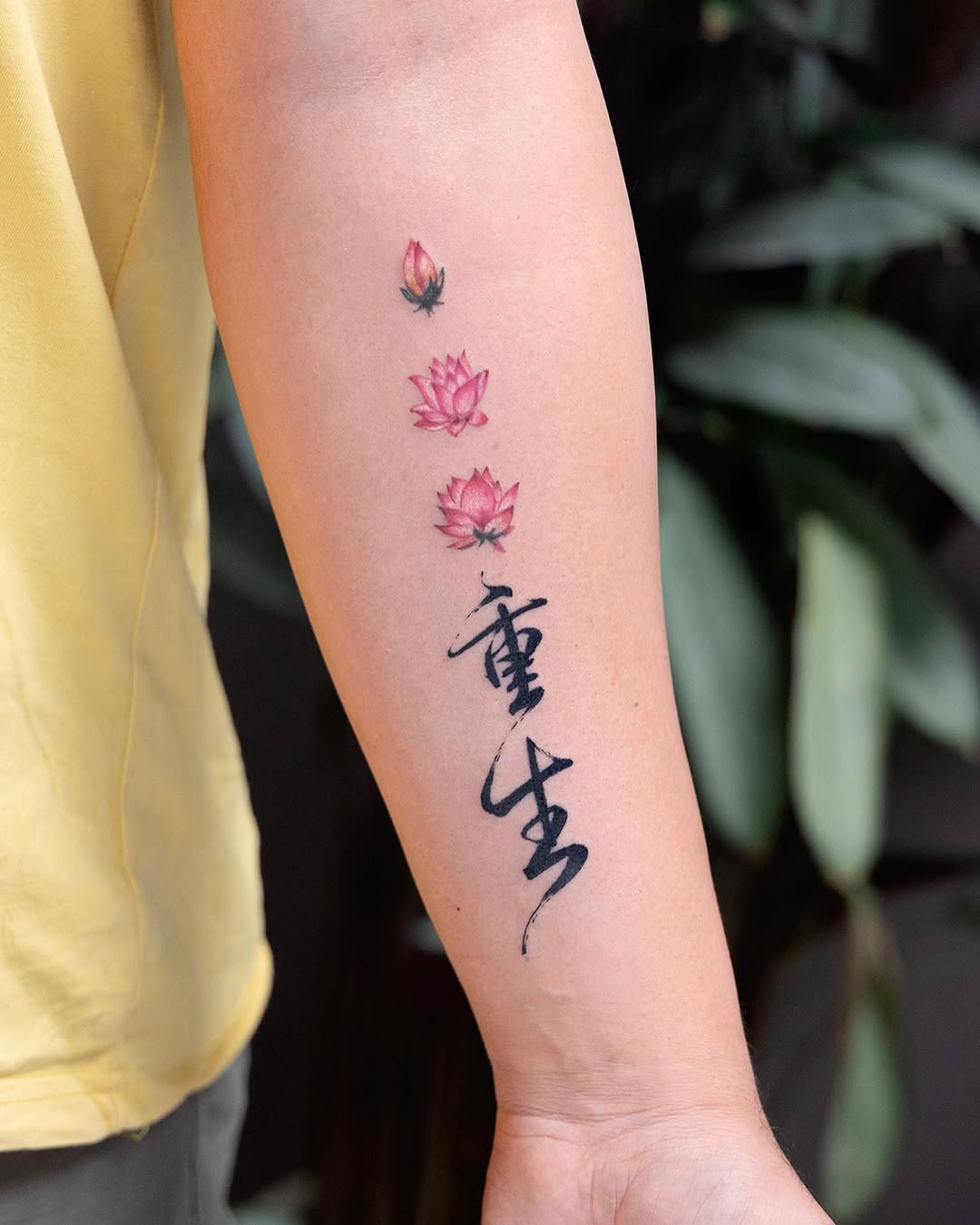 Elegant red lotus tattoo on inner bicep Tattoo Design