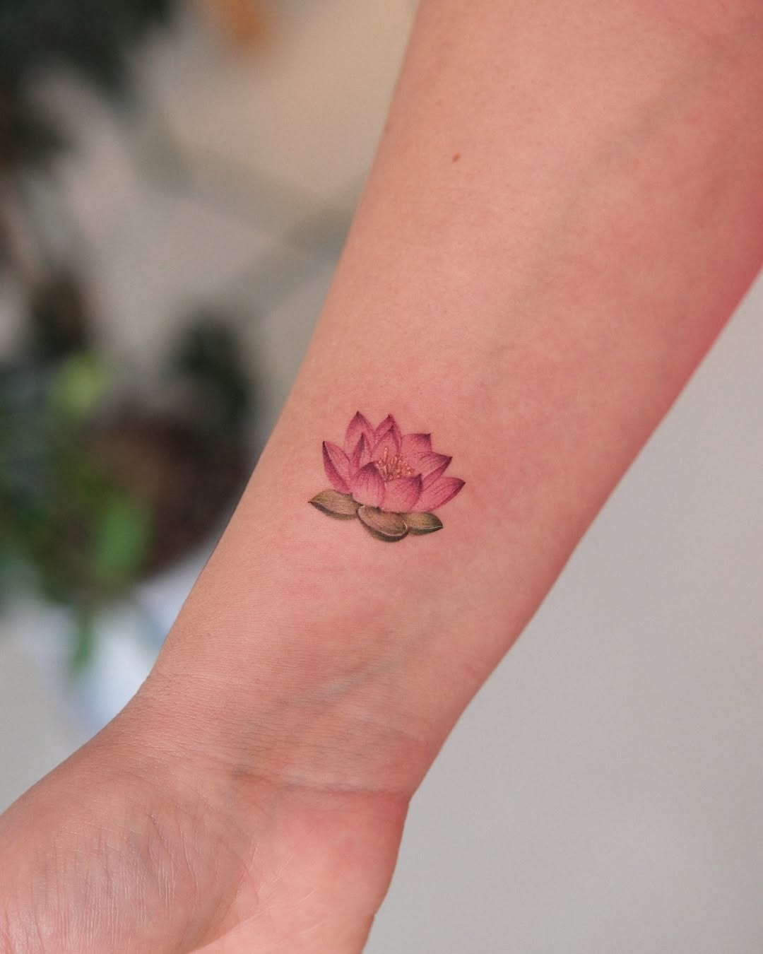 Vibrant pink lotus tattoo on the arm Tattoo Design