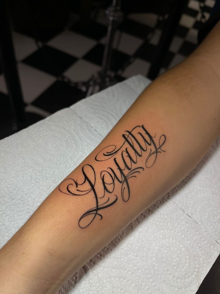 Loyalty Tattoo Across the Hand Side Tattoo Design