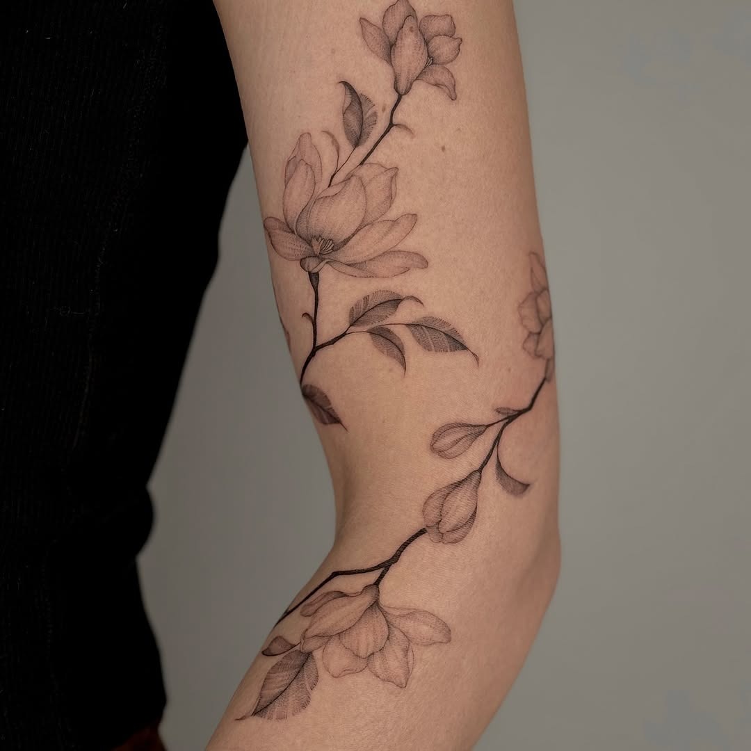 Elegant floral design wraps around the elbow Tattoo Design