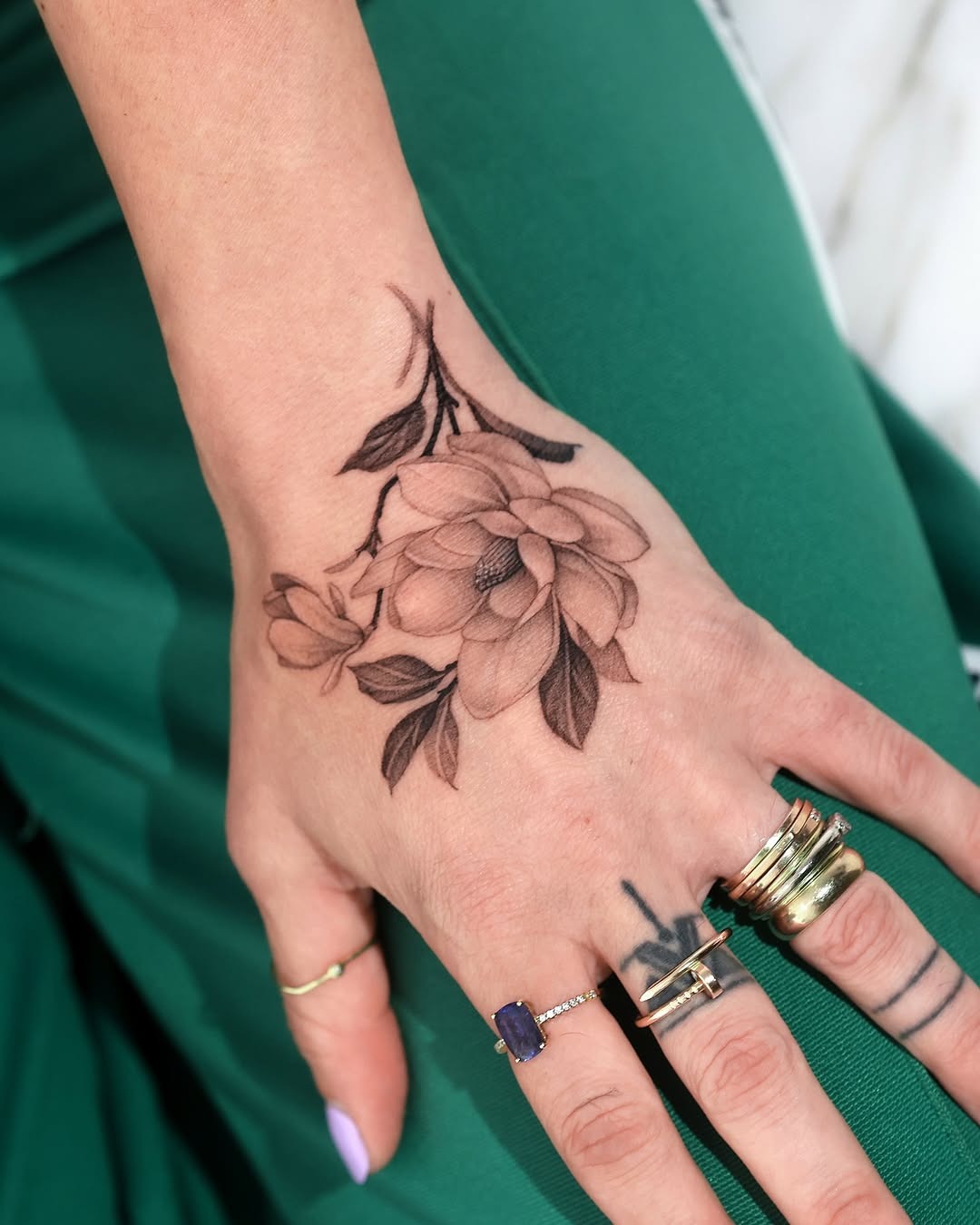 Elegant magnolia tattoo adorning the hand Tattoo Design