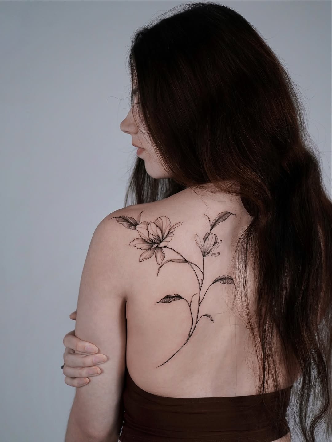 Elegant Magnolia Tattoo on the Back Tattoo Design