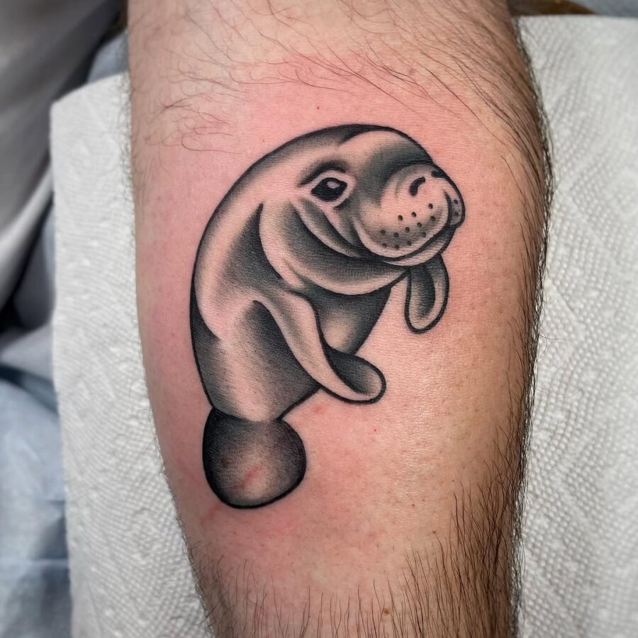 This manatee tattoo showcases a beautiful, lifelike portrayal of the gentle giant.