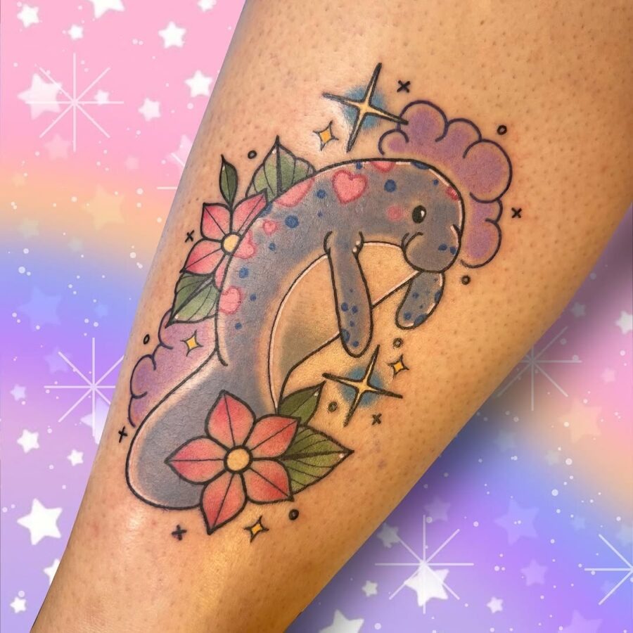 This tattoo showcases a playful manatee surrounded by flowers and clouds.