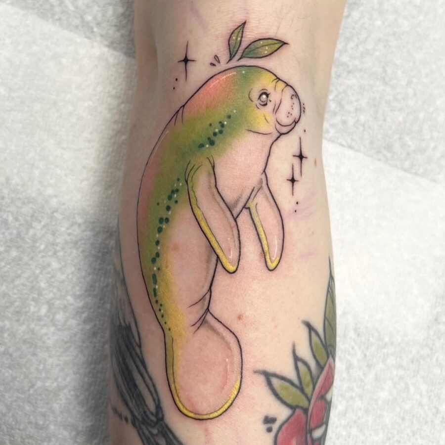 This manatee tattoo bursts with color and charm.