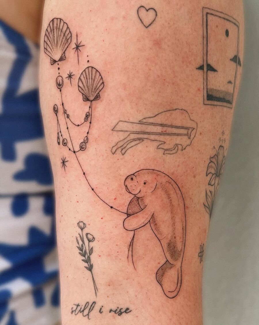 This tattoo showcases a sweet manatee surrounded by shells and flowers.