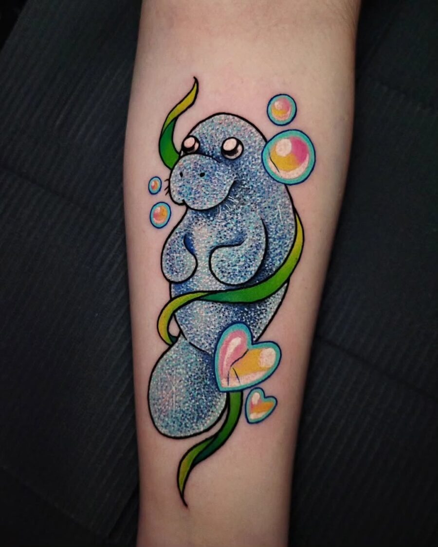 This delightful manatee tattoo features a sparkling blue design, embodying the charm of these gentle sea creatures.