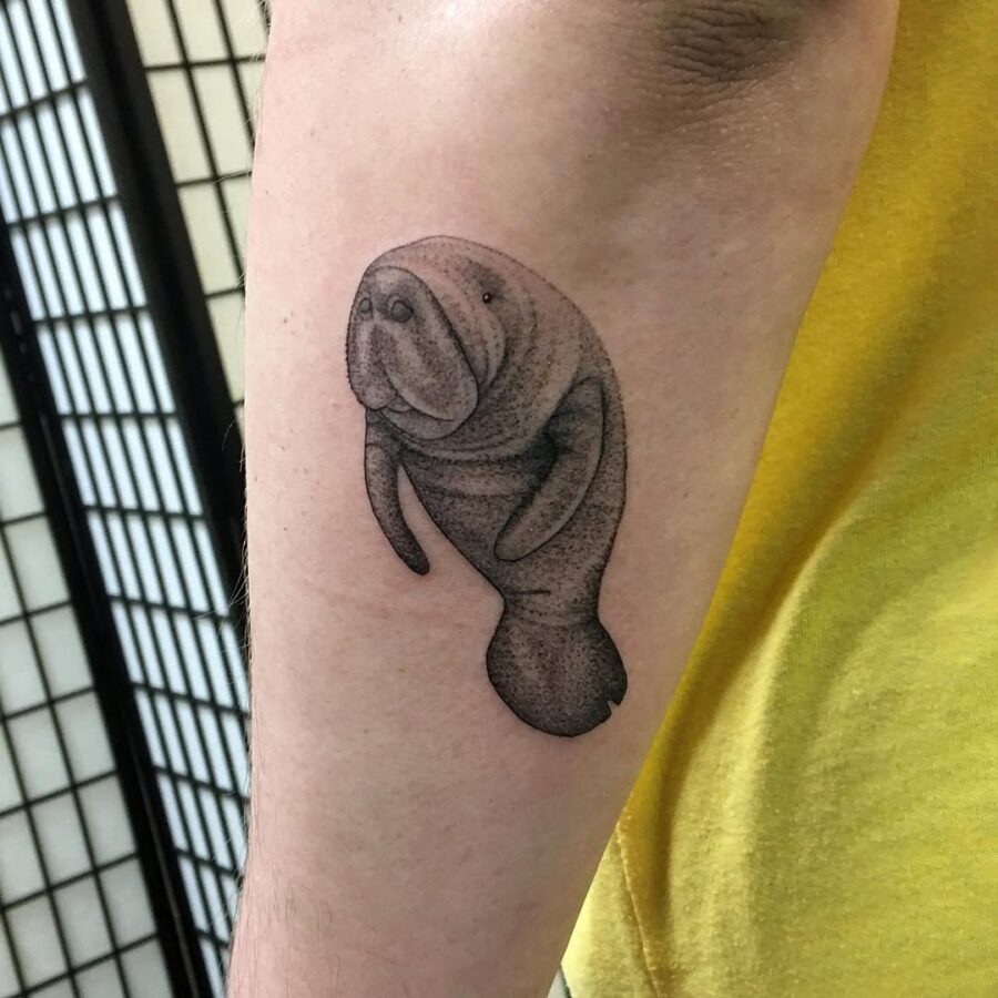 This tattoo features a beautifully detailed manatee, capturing the gentle spirit of these ocean-loving creatures.