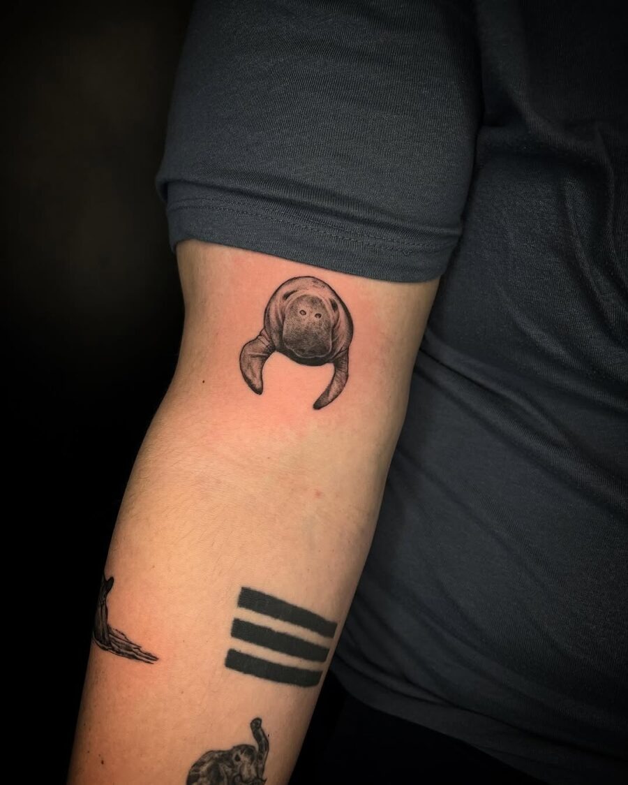 This stunning manatee tattoo showcases intricate detailing, capturing the gentle spirit of this beloved marine mammal.