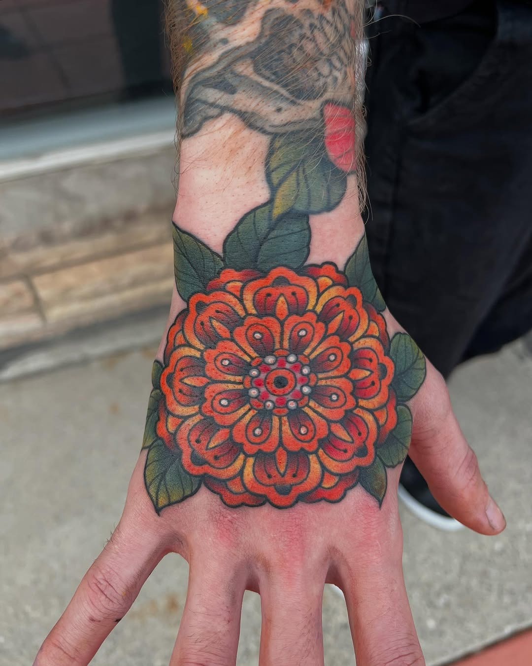 Bold marigold tattoo on hand showcases beauty Tattoo Design