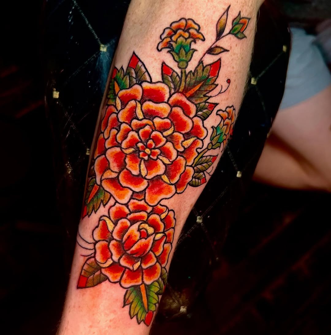 Bold marigold tattoo with vibrant floral elements Tattoo Design