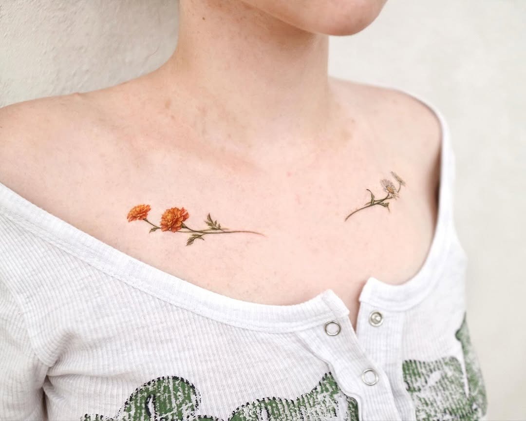 Delicate marigold tattoos gracefully adorn shoulders Tattoo Design
