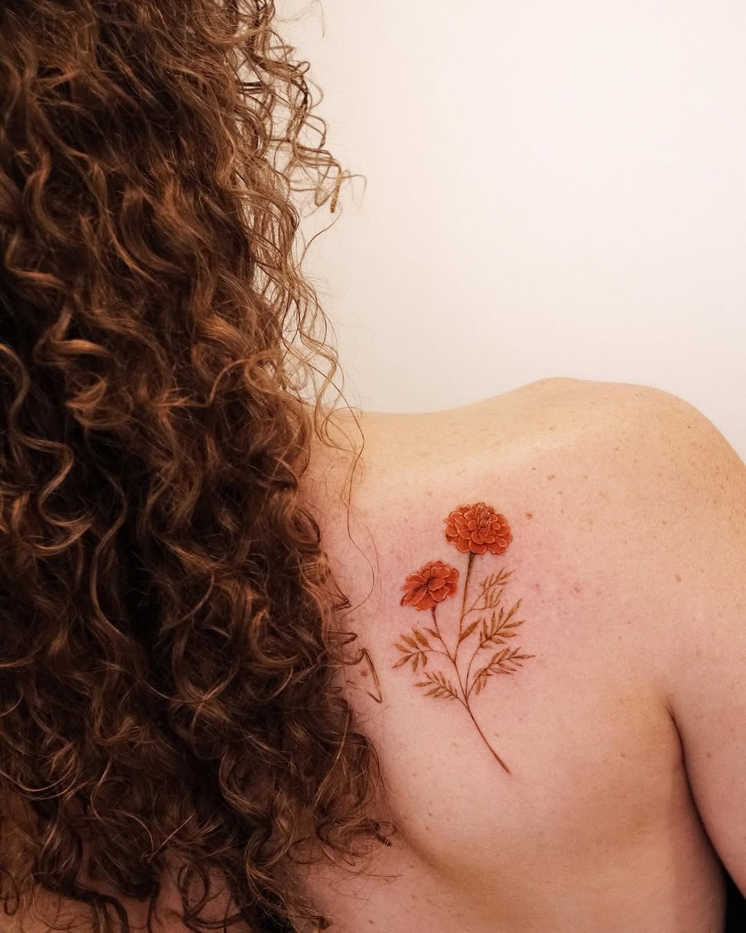 Elegant marigold tattoo on shoulder area Tattoo Design