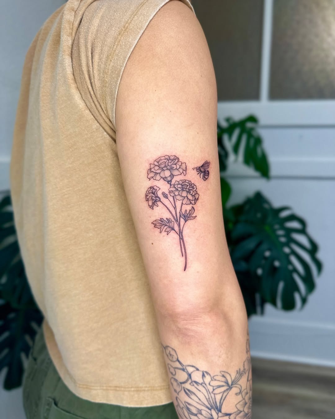 Elegant marigold tattoo with delicate bee Tattoo Design