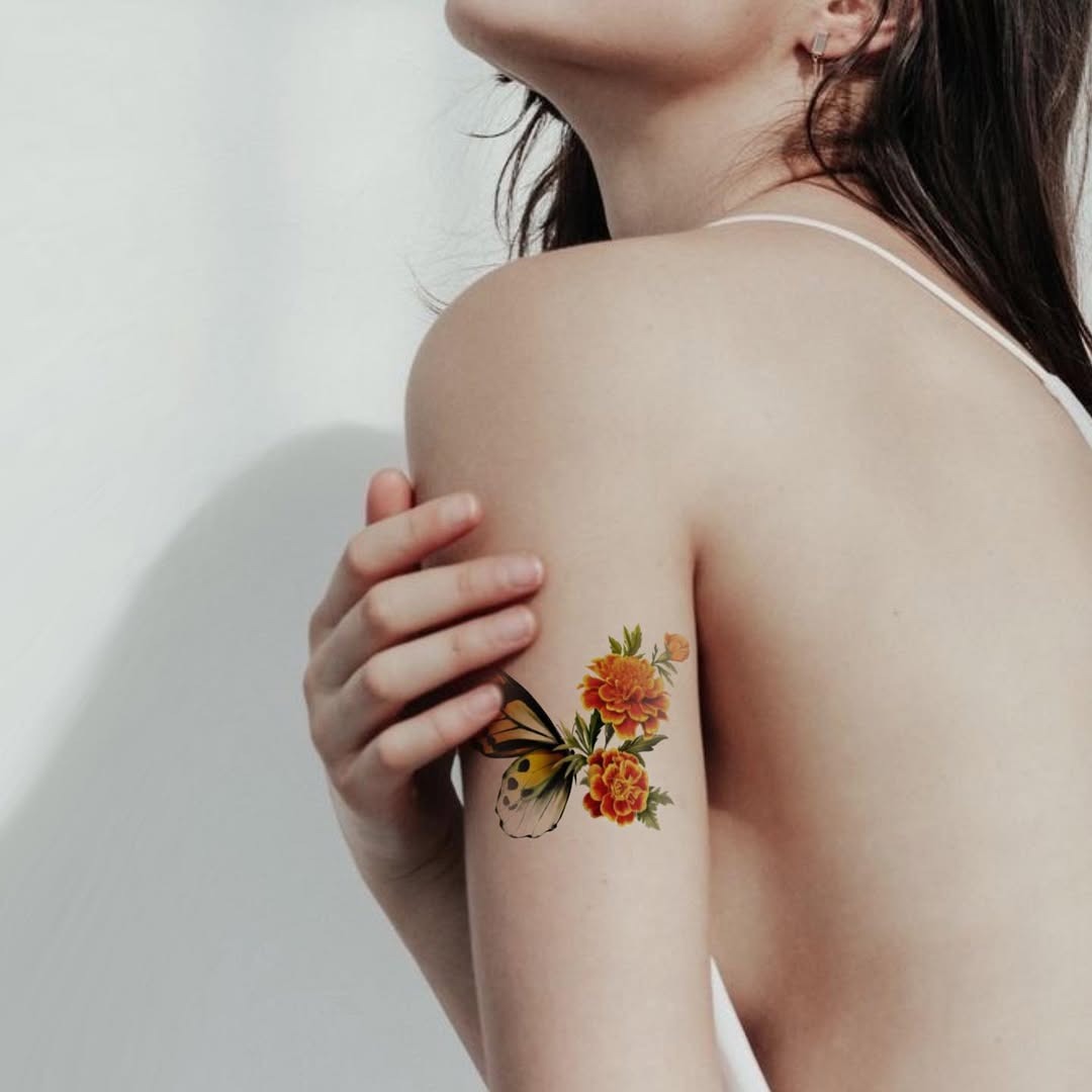 Stunning marigold tattoo with butterfly accent Tattoo Design
