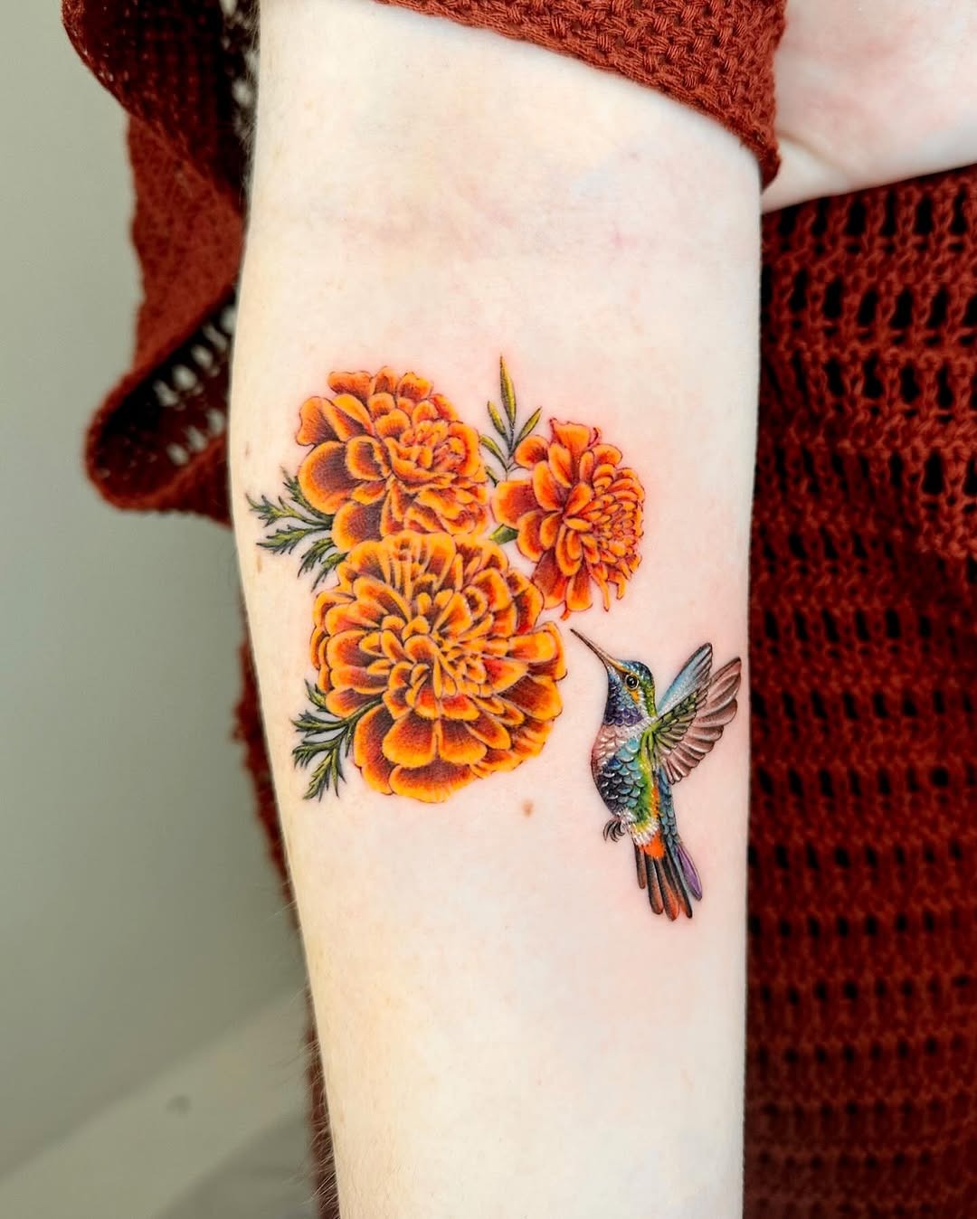 Stunning marigold tattoo with hummingbird Tattoo Design