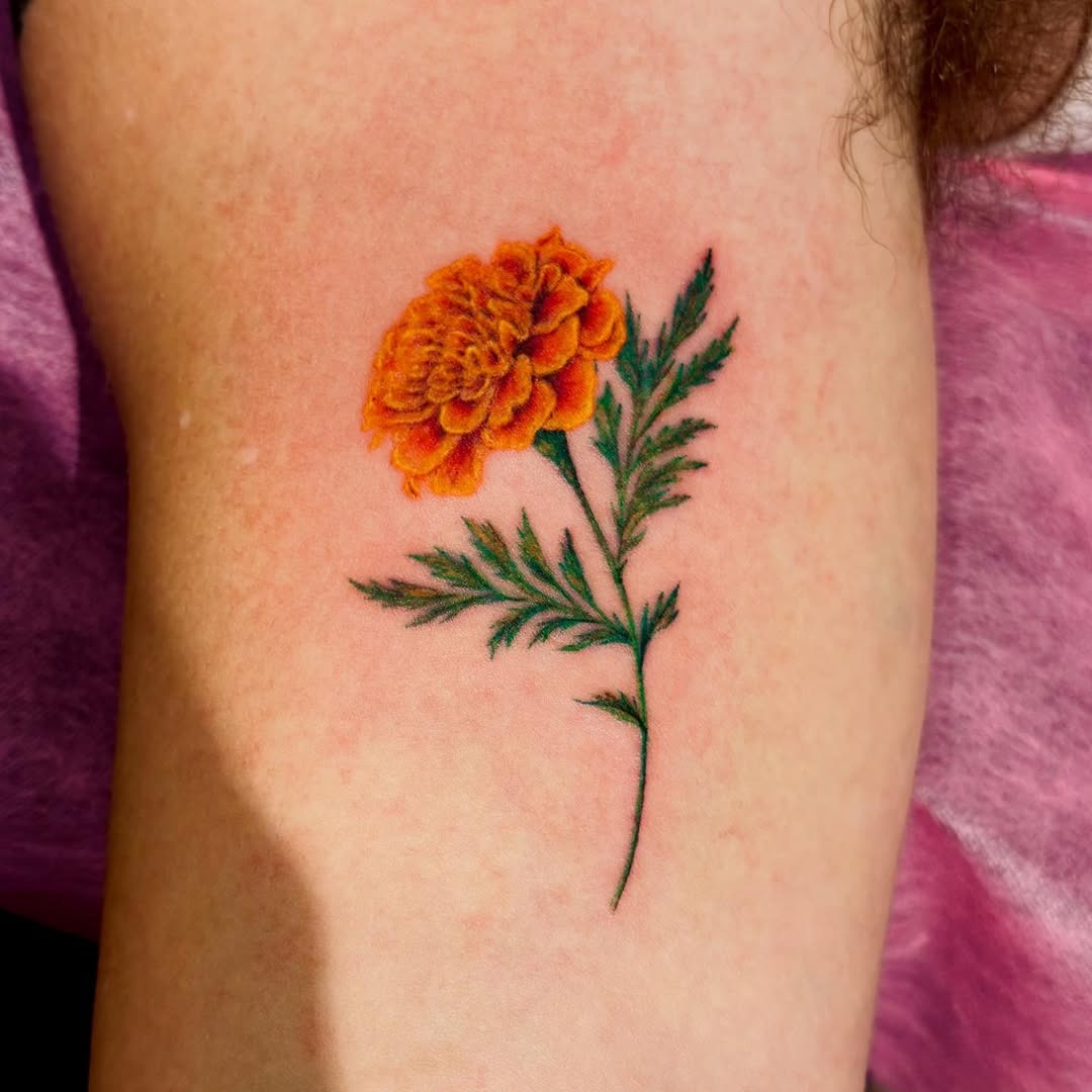 Stunning marigold tattoo with striking colors Tattoo Design