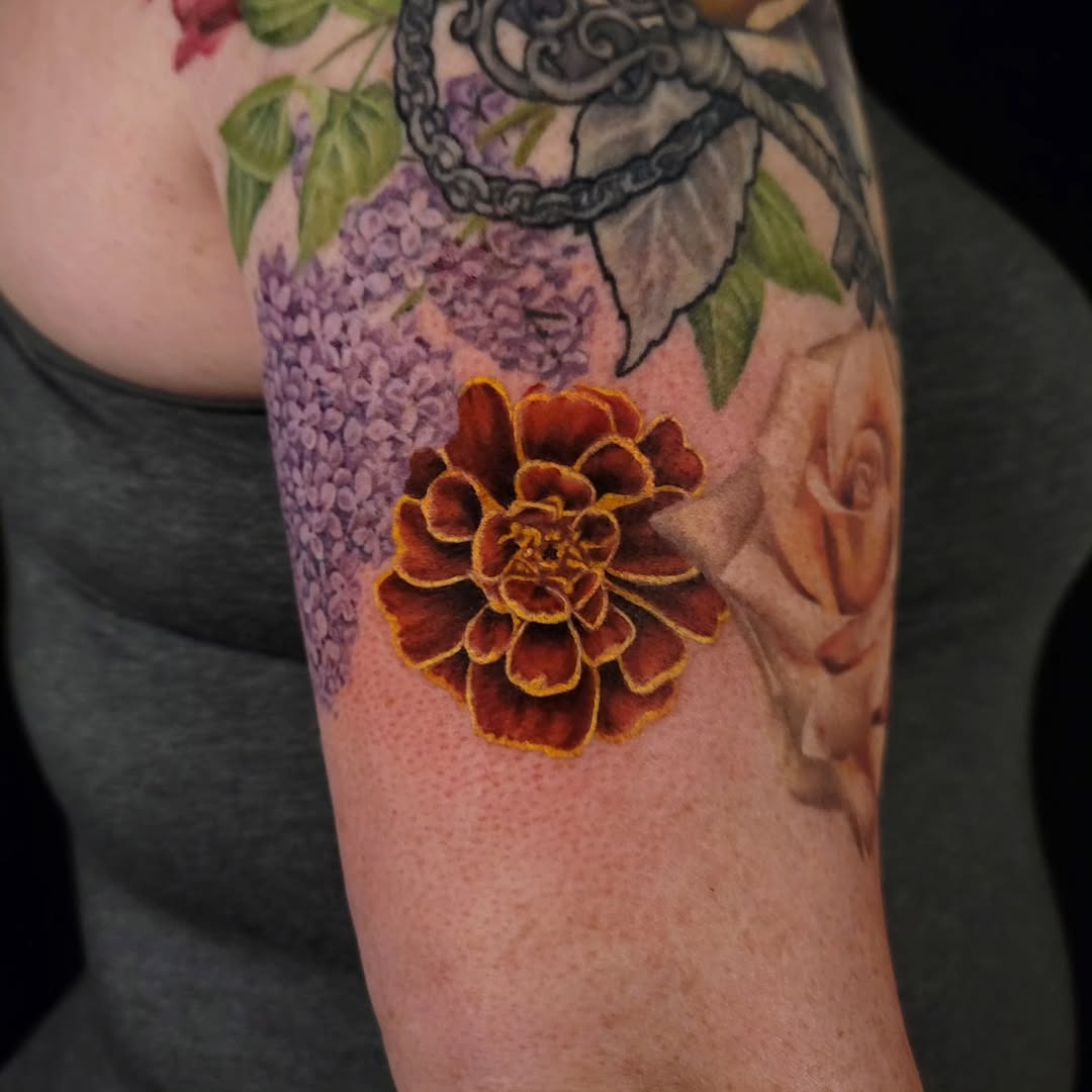Vibrant marigold flower tattoo in full bloom Tattoo Design
