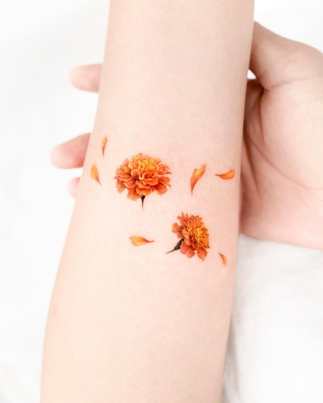 Vibrant marigold tattoo with delicate petals. Tattoo Design