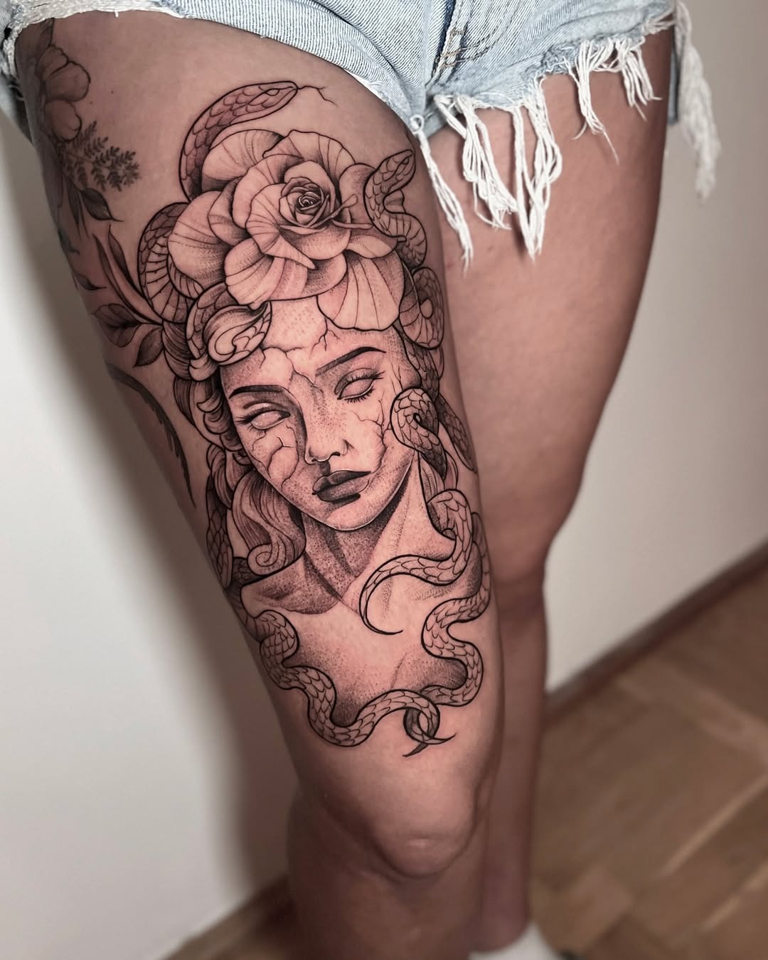 Intricate Medusa Tattoo with Floral Elements Tattoo Design