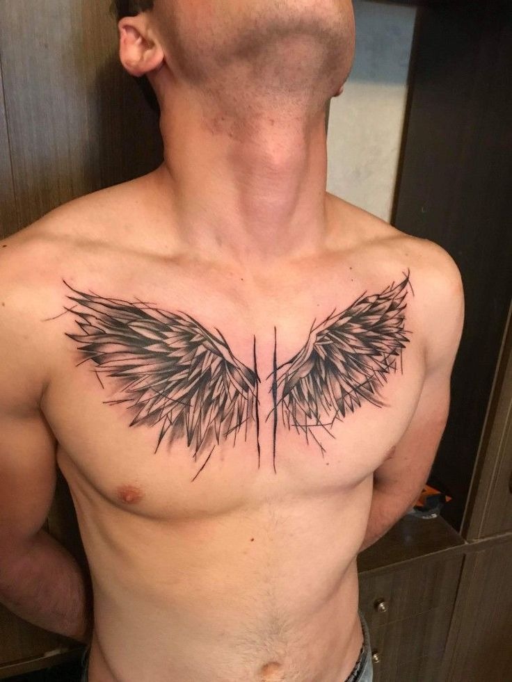 This highly stylized angel wings tattoo on chest uses sharp, shard-like feathers that create a fractured, almost crystalline effect.