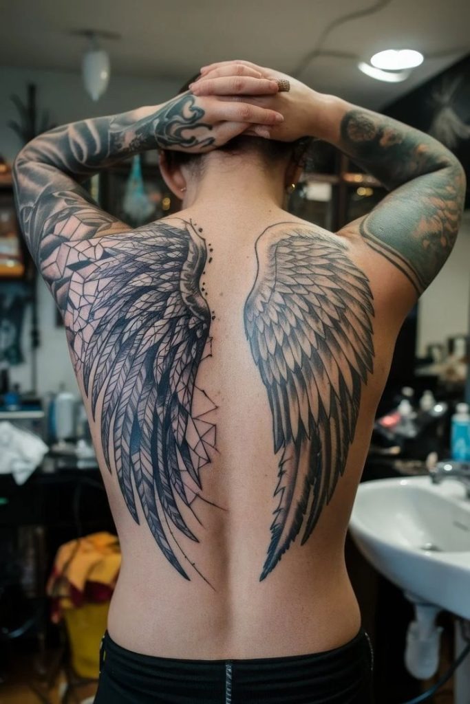 This striking angel wings tattoo on back merges realism with modern design.